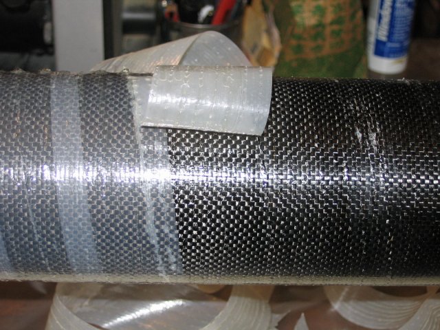 unwrapping heat shrink tape from carbon fiber laminated aiframe tube